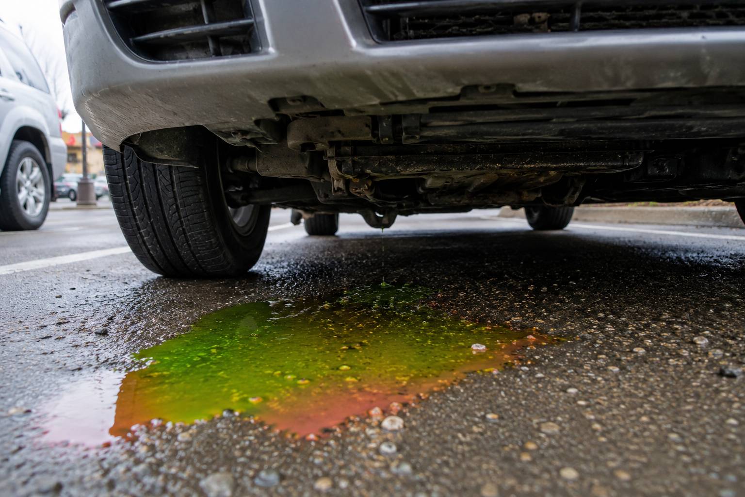 A green, orange, or pink puddle under your car indicates a dangerous coolant leak..